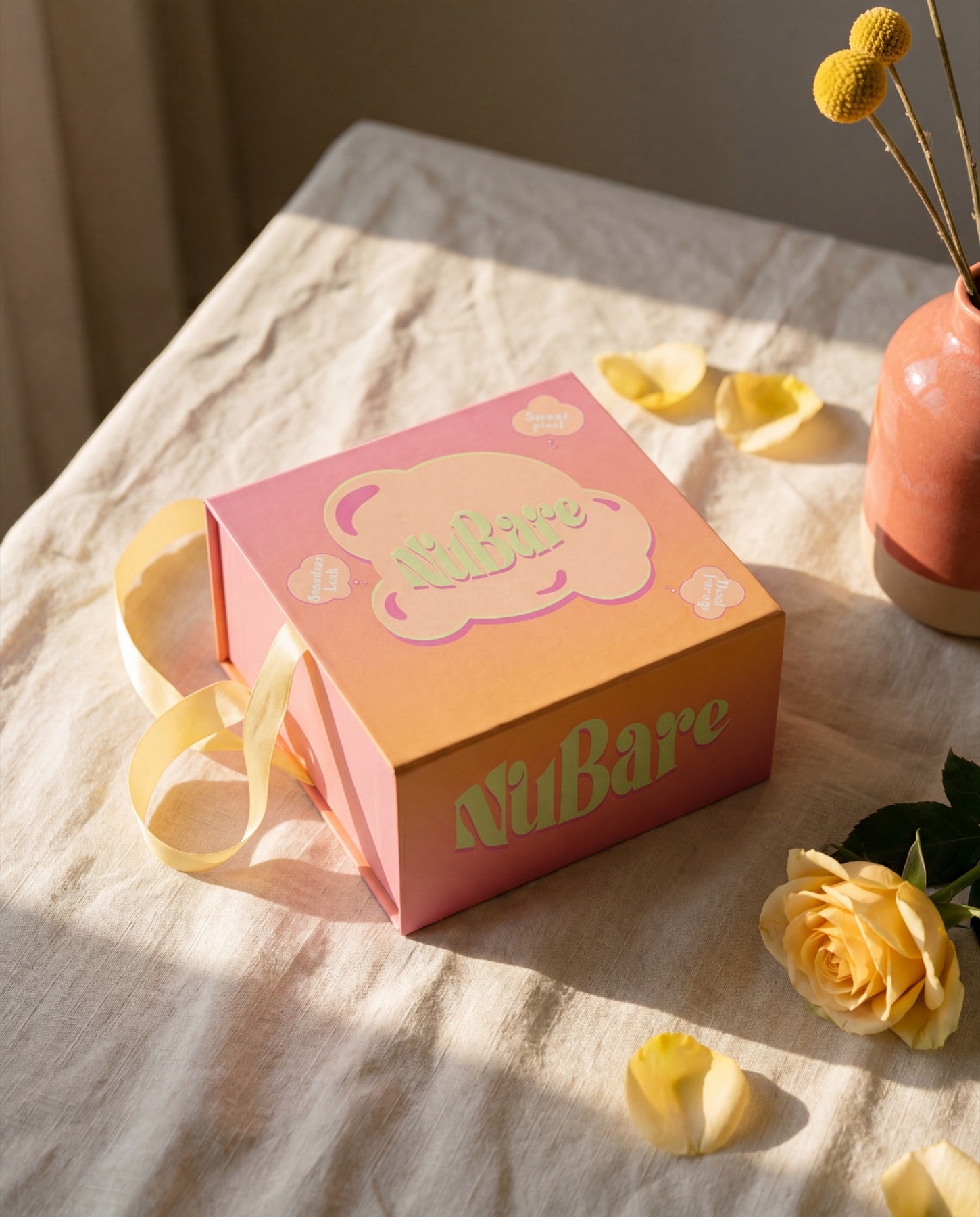 Nubare gift box, closed — butter ribbon styling
